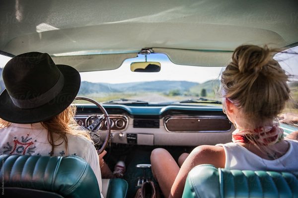 Two Women Driving In A Vintage Car Looking Out At The Open Road by Shaun Robinson